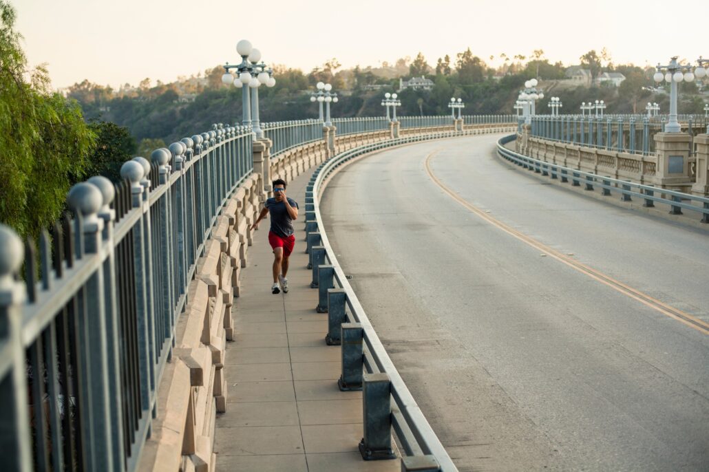 Jogger running on bridge, Arroyo Seco Park, Pasadena, California, USA